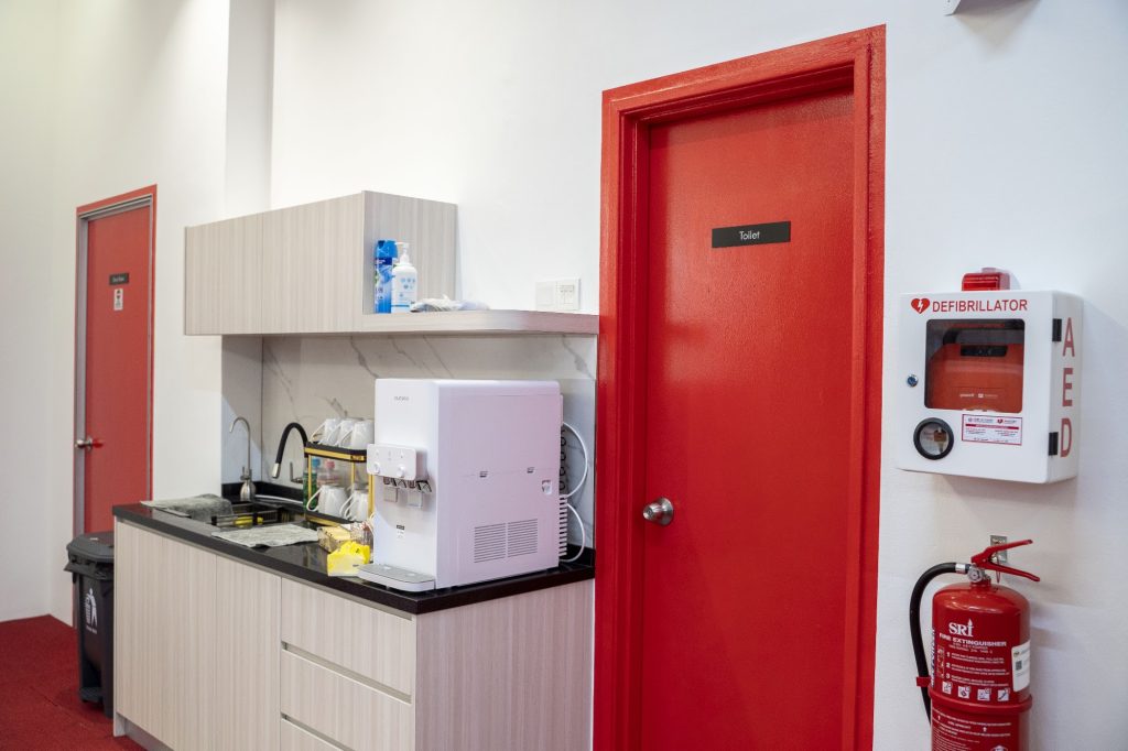 Pantry with water dispenser, AED and fire extinguisher at CERT Academy